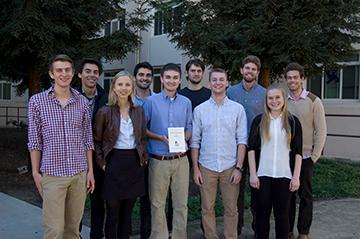 A group of people standing outside at a physics symposium.