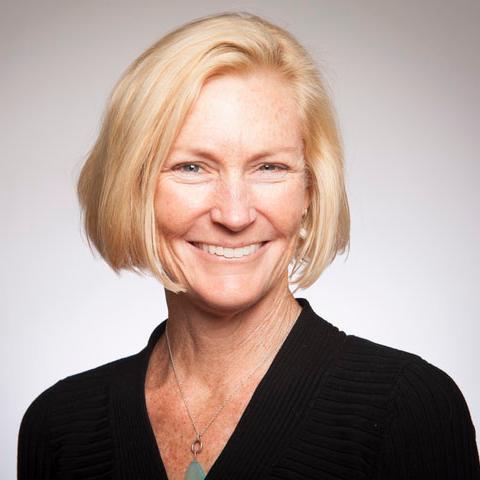 A person smiling in a professional portrait.