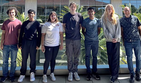Paul Abbyad with his undergraduate research group of 4 male and 2 female students outside a building