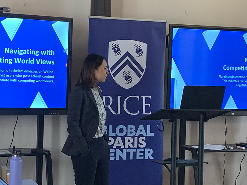 Di Di standing while presenting