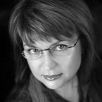 Black and white portrait of a person wearing glasses, titled 