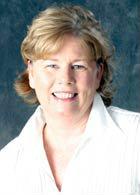 A person smiling in a white shirt, titled 