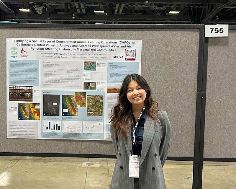 Stephanie Davis standing next to her research poster.
