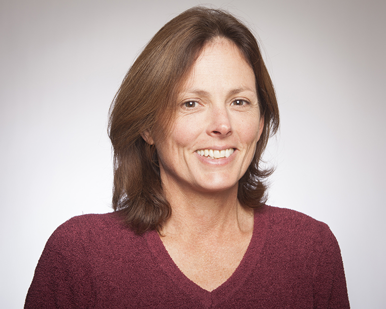 Alt text: Person smiling in a maroon shirt.