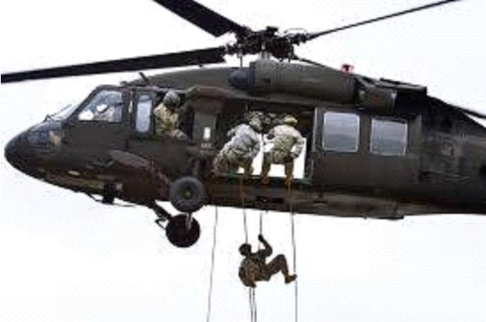 Soldiers rappelling from a helicopter during an air assault operation.