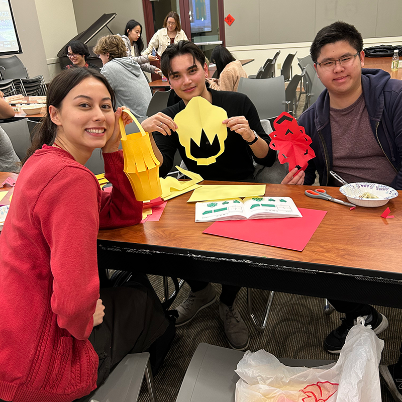 Students making paper lanterns at Chinese New Year celebration.
