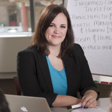 Dr. Meghan Clark sitting at her desk in front of her computer