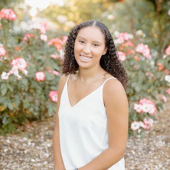 Amana Liddell in front of flowers