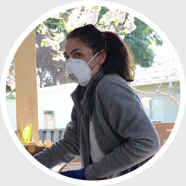 Person wearing a face mask inside a white circular frame.