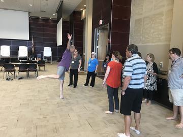 People during warm-up session in a large indoor space.