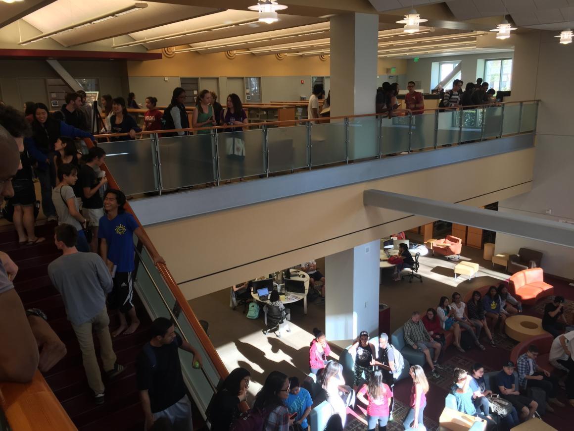 Students gather in a multi-level library during a study break.