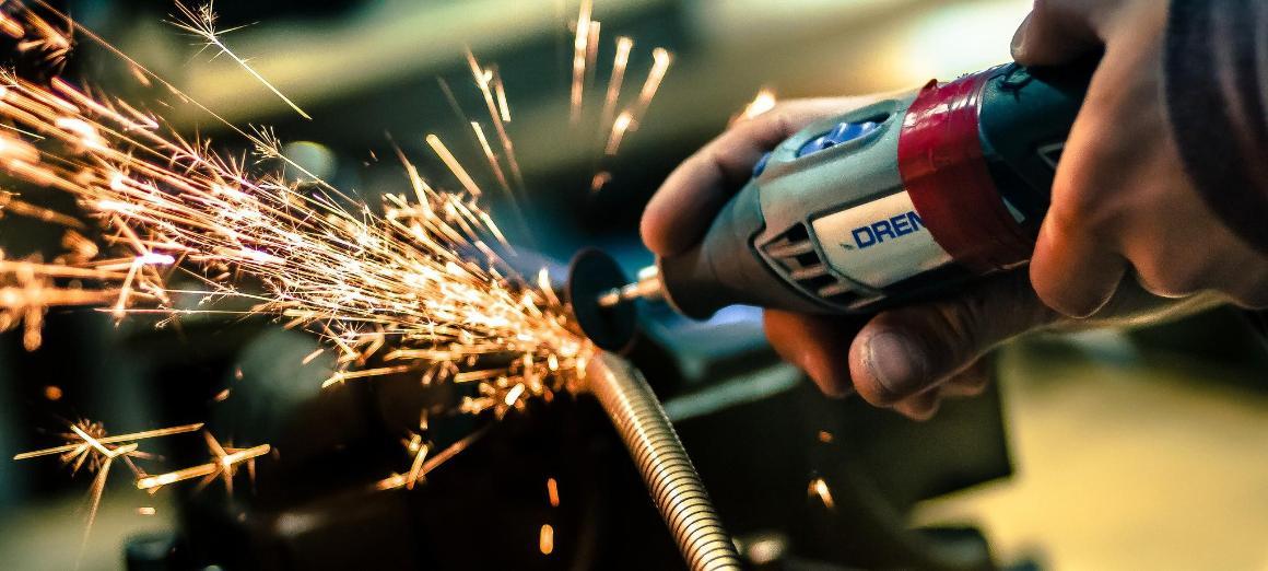 Image of drill connecting with metal tube and causing sparks