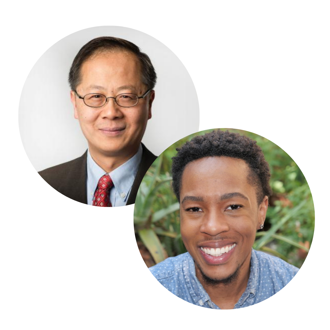 Two men, one wearing glasses and a suit, the other smiling in a casual shirt.