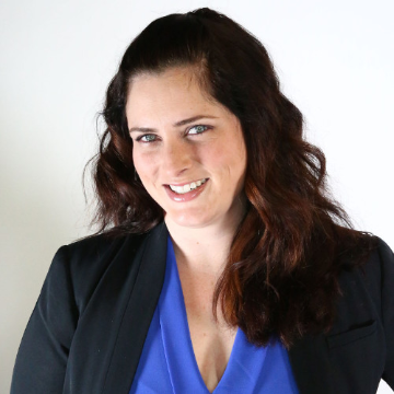 A woman smiling in business attire. image link to story