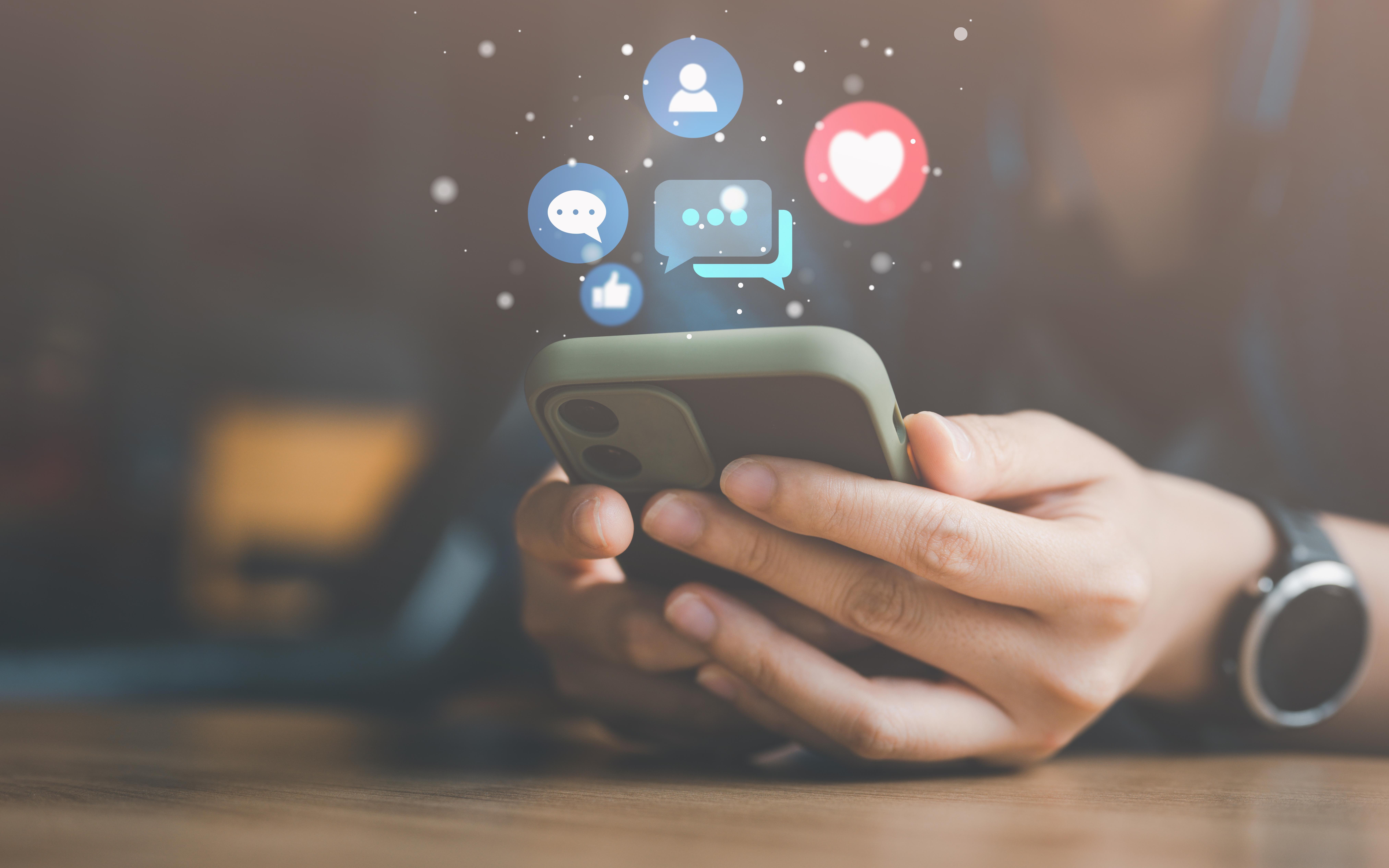 Woman interacting with smartphone device for social media communication and entertainment. Photo by See Less via Adobe Stock.