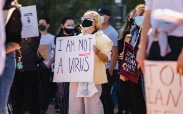 Protester holding sign that reads, 