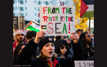 A protester carries a sign that reads, 
