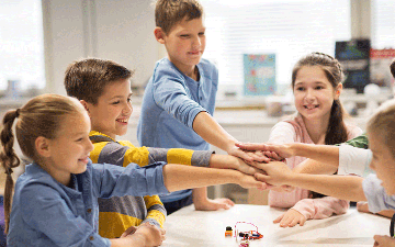 Kids putting their hands together