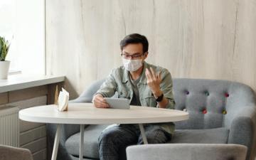 A man talking and looking at his phone. Photo Credit: Edward Jenner/Pexels 