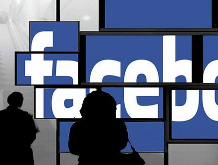 people silouetted in front of blue screens