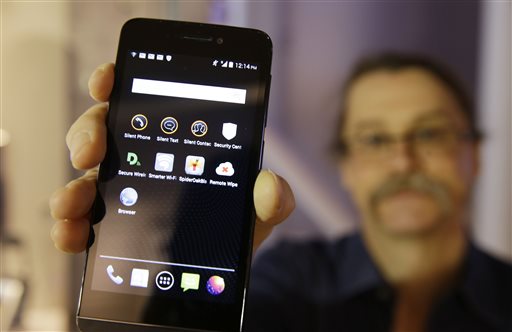 FILE - In this July 30, 2014, file photo, Silicon Valley pioneer and Silent Circle co-founder Jon Callas holds up Blackphone with encryptionapps displayed on it at the Computer History Museum in Mountain View, Calif. The Paris terrorist attacks have renewed the debate between law-enforcement officials and privacy advocates over whether there should be limits to encryption technology. (AP Photo/Eri