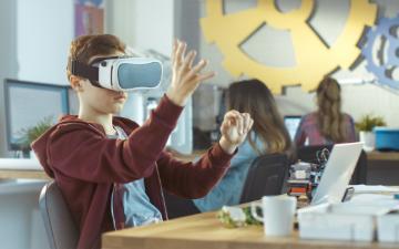 Students using virtual reality headsets in a classroom setting.