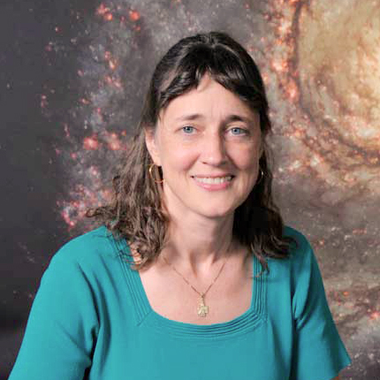 A person in a teal shirt in front of a galaxy backdrop.