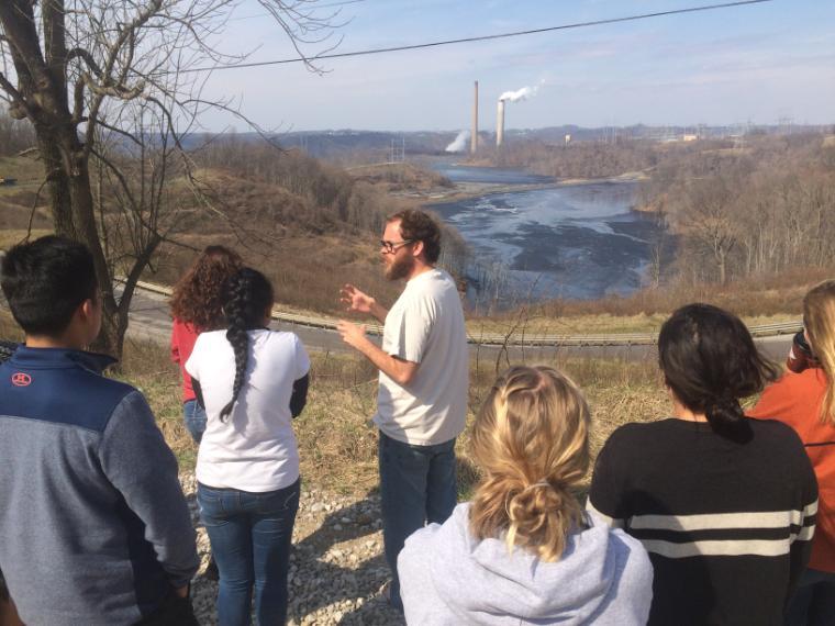 People listening to a guide with a scenic Appalachian backdrop.