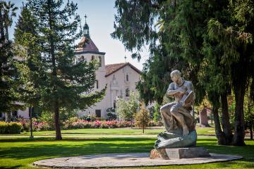 St. Ignatius statue with Mission Church in background 