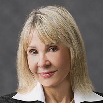 Agnieszka Winkler smiling, wearing a black jacket with white collar.