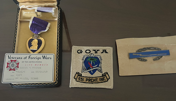 A Purple Heart medal, a battalion patch, and a artillery medal.