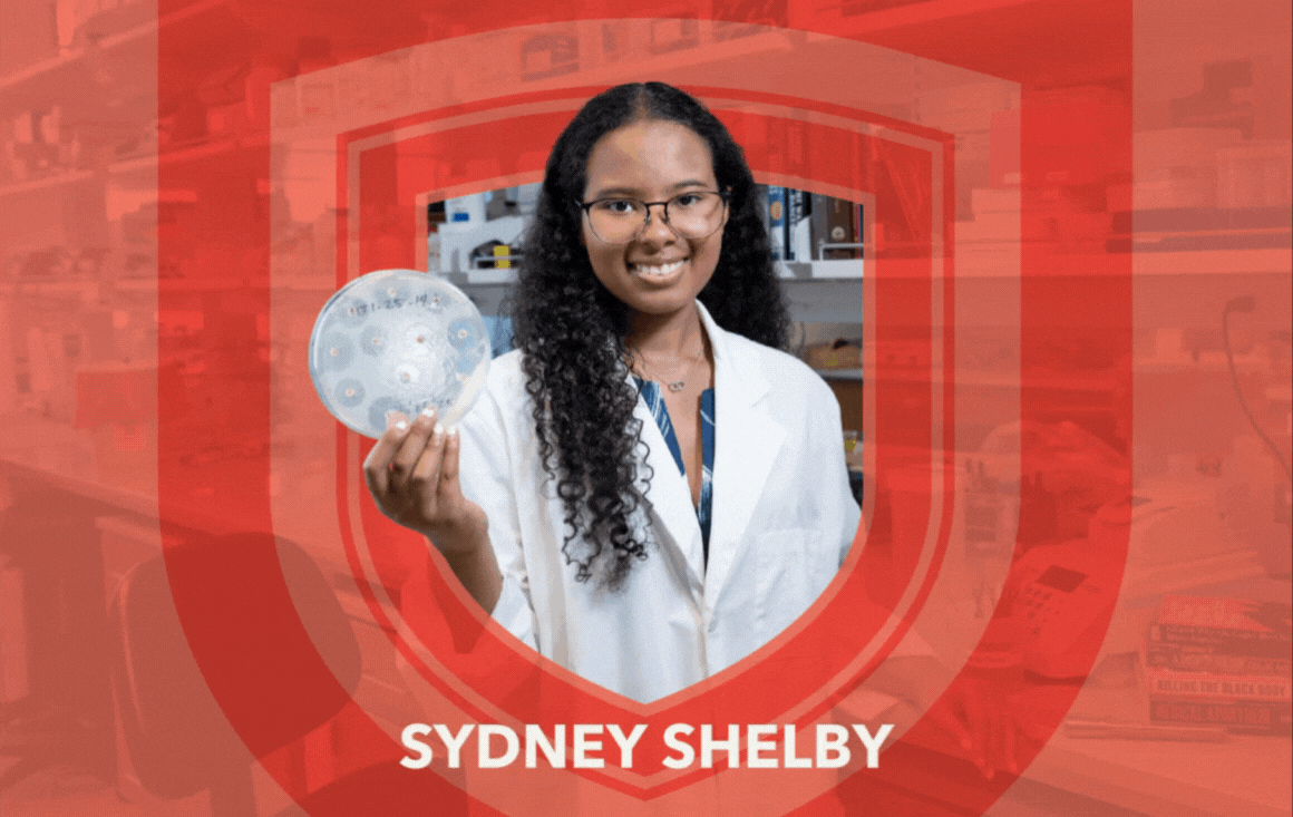 Sydney Shelby holds a Petri dish in a biology lab.