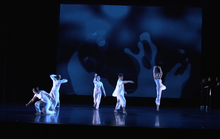SCU dancers in front of a dark backdrop for The Water Project image link to story