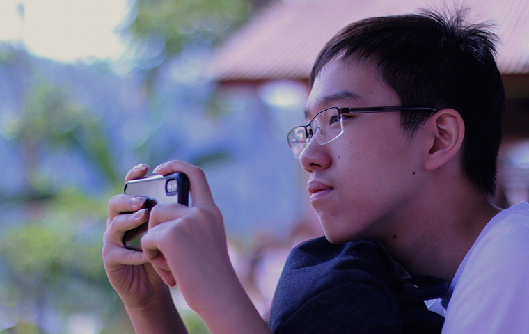 Bryan Alexander looks through his phone camera