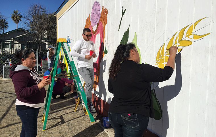 People painting a mural
