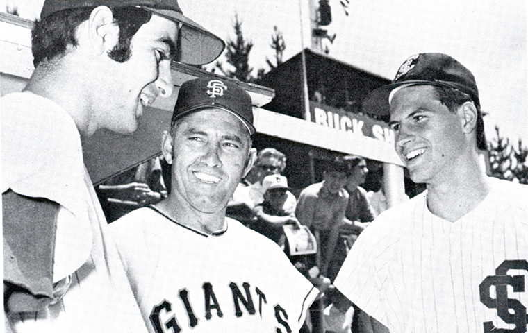 Pitchers from the SCU baseball team and SF Giants talk on field. 