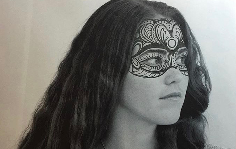 Student with face paint looking off to the right.