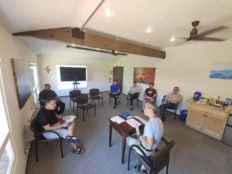 Students in classroom with priest 