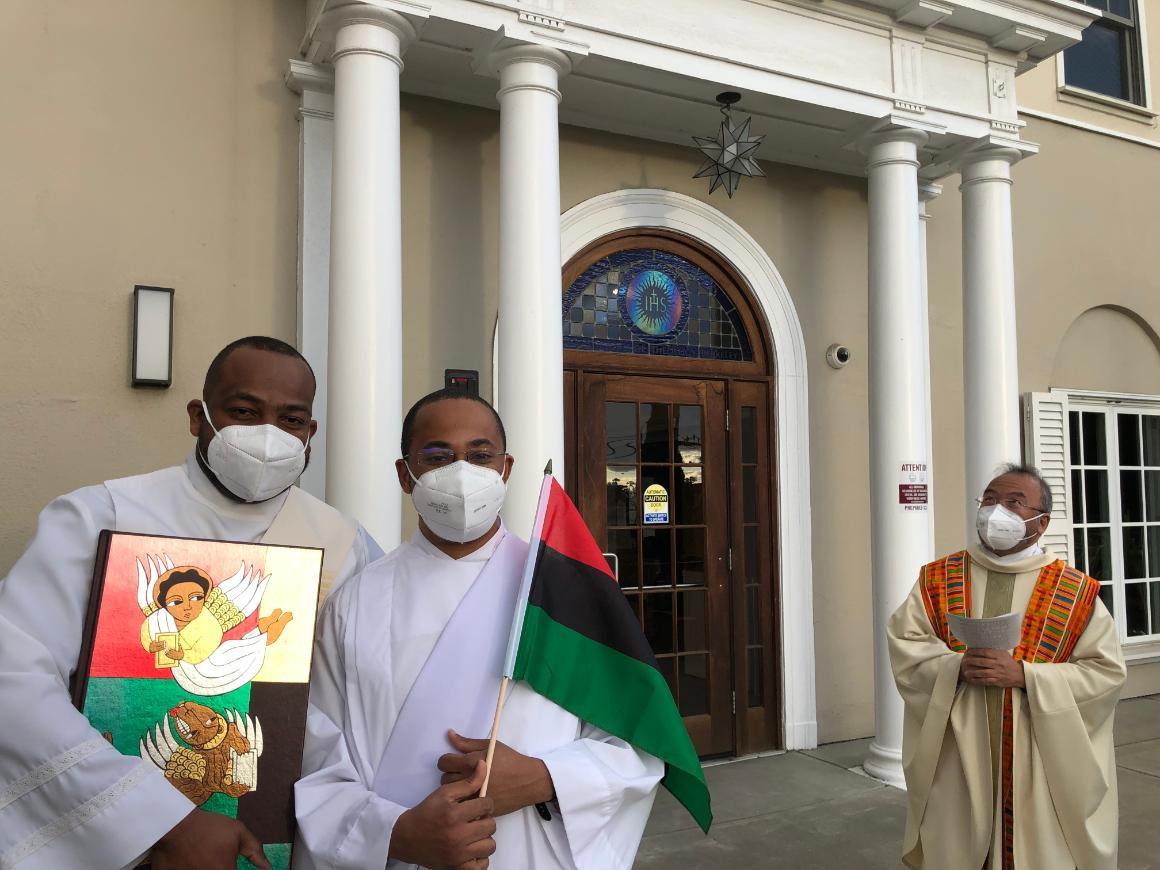 students holding flags and photos in honor of Black History Month