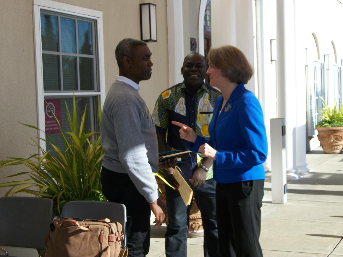 STD student Taiye Obada and STL student Jean Claude Rimasbe Dionba chat with Interim Dean Alison Benders before the Mass of the Holy Spirit, September 6