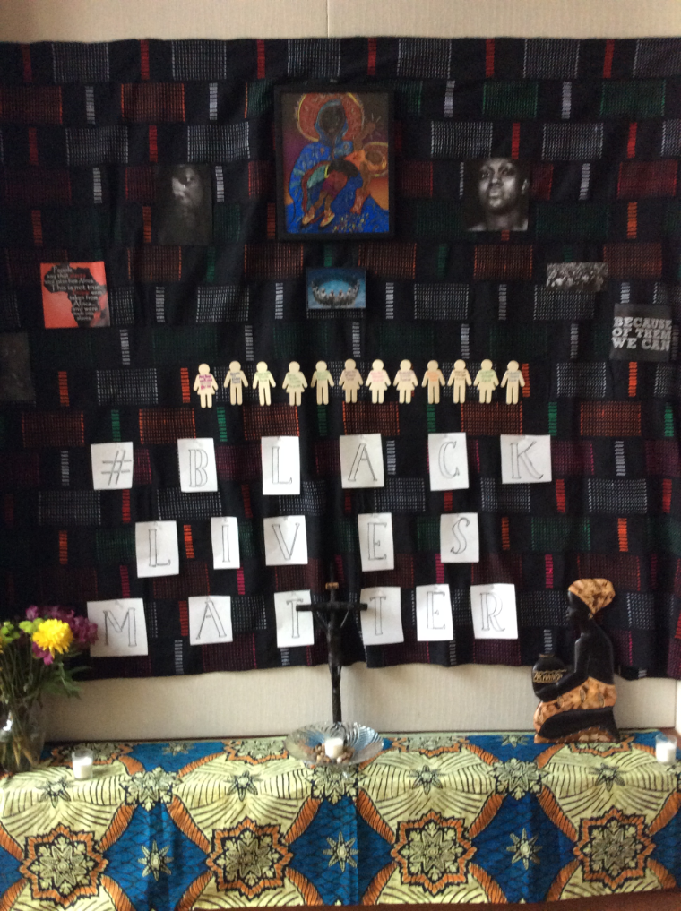 Black History Month altar with photos, candles, and decorations.
