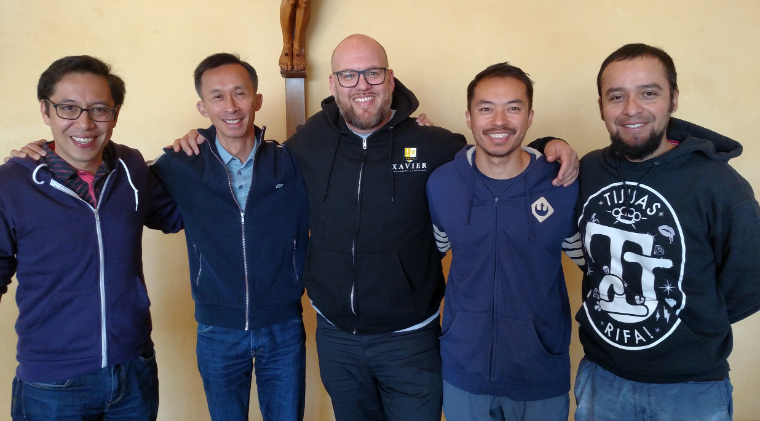Five men standing together, one wearing clerical clothing, during Diaconate Ordination (Fall 2019).
