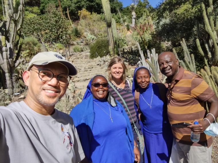 A group of five people smiling at UC Botanical Garden.