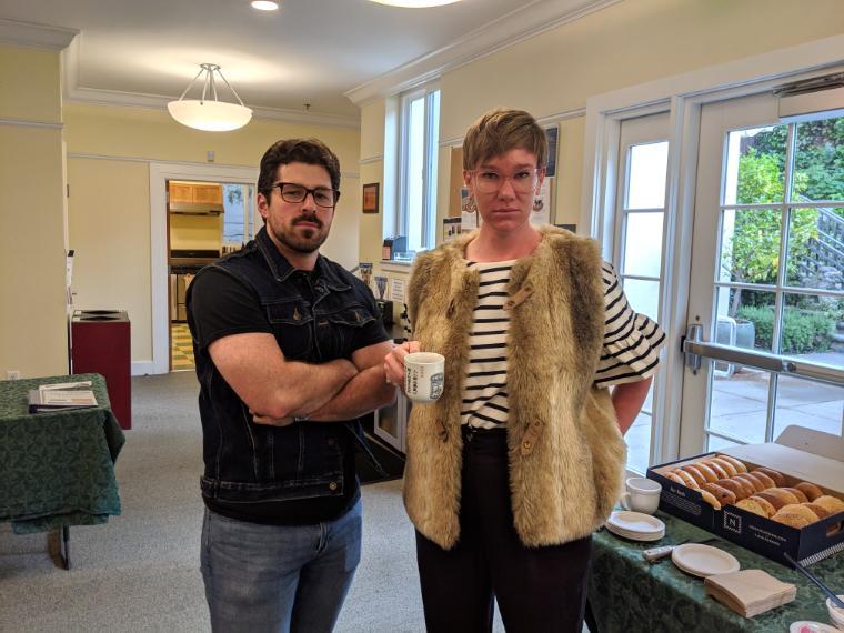 Two people posing indoors at the MDiv III Comps Breakfast.