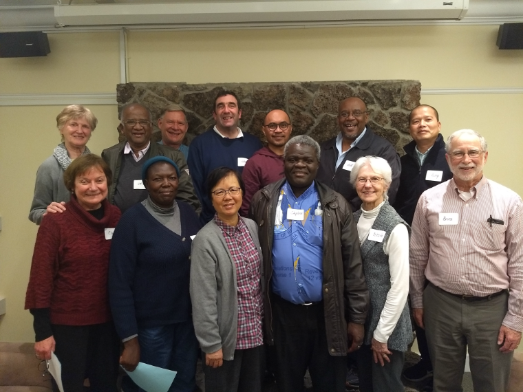 students and spiritual directors in front of fireplace