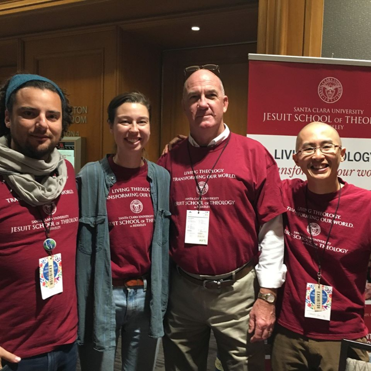 Four people wearing matching red 