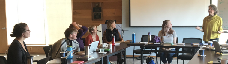 Women gathering around a table with books, possibly for the Liturgy of the Hours.