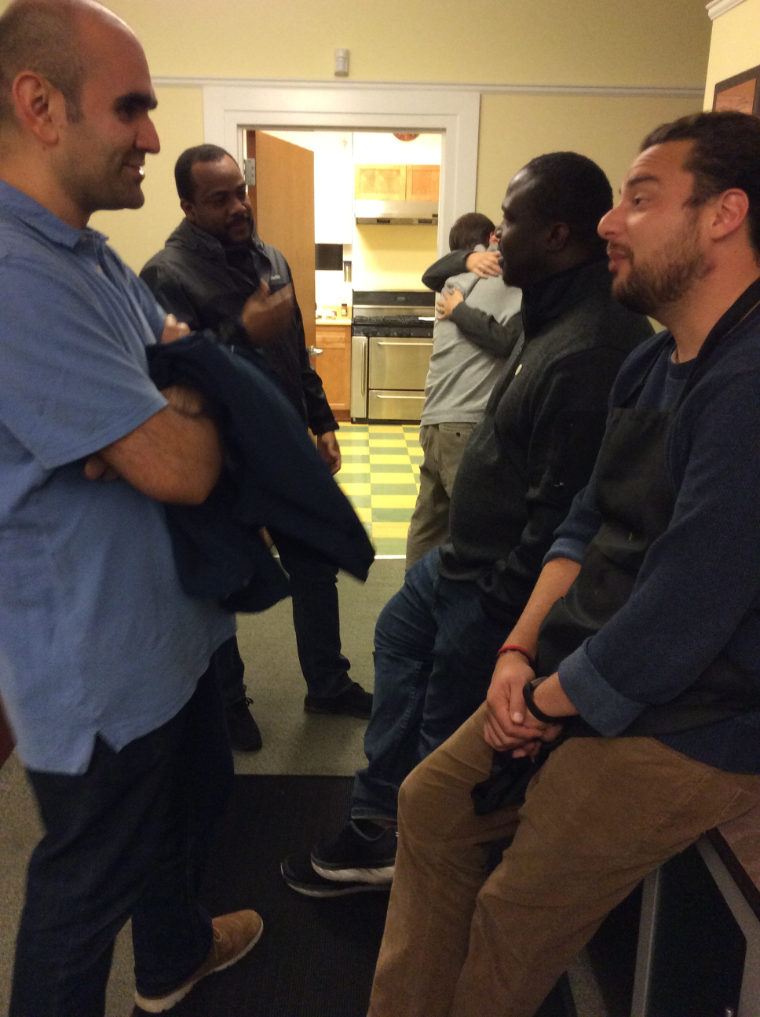 Group of people talking in a room.