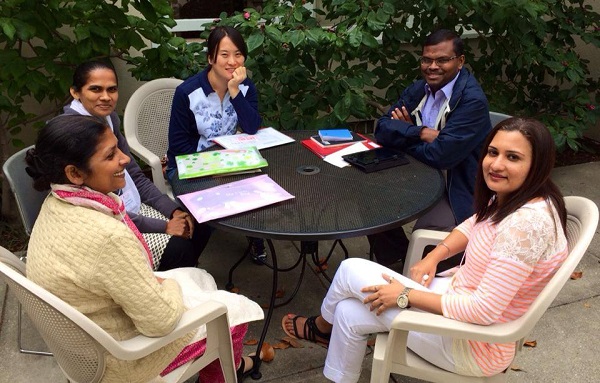 students around table on patio