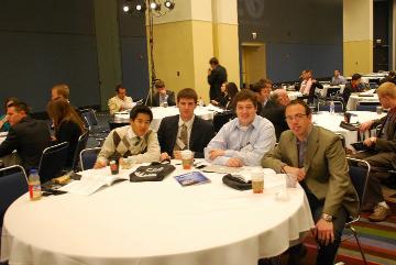 People sitting at a round table at a conference.